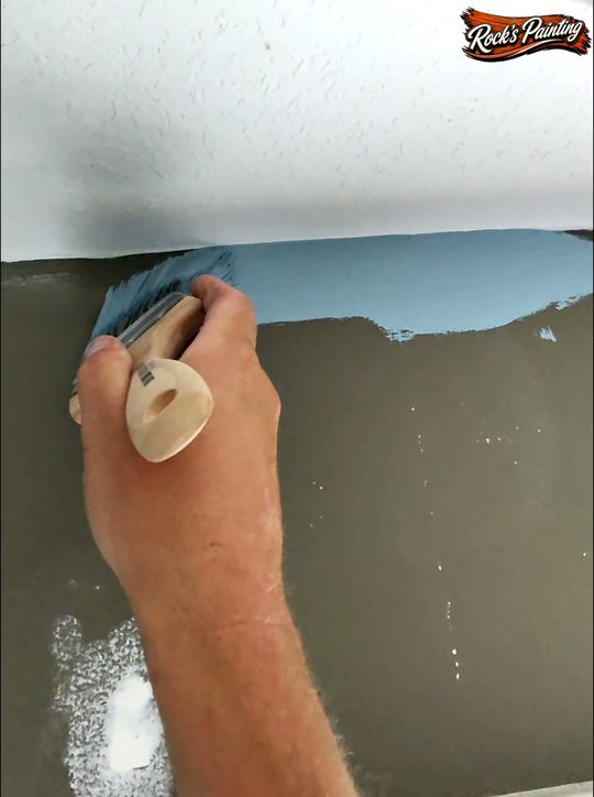 Cutting in Emerald Symmetry slate blue paint over taupe walls with a Purdy Spirex brush
