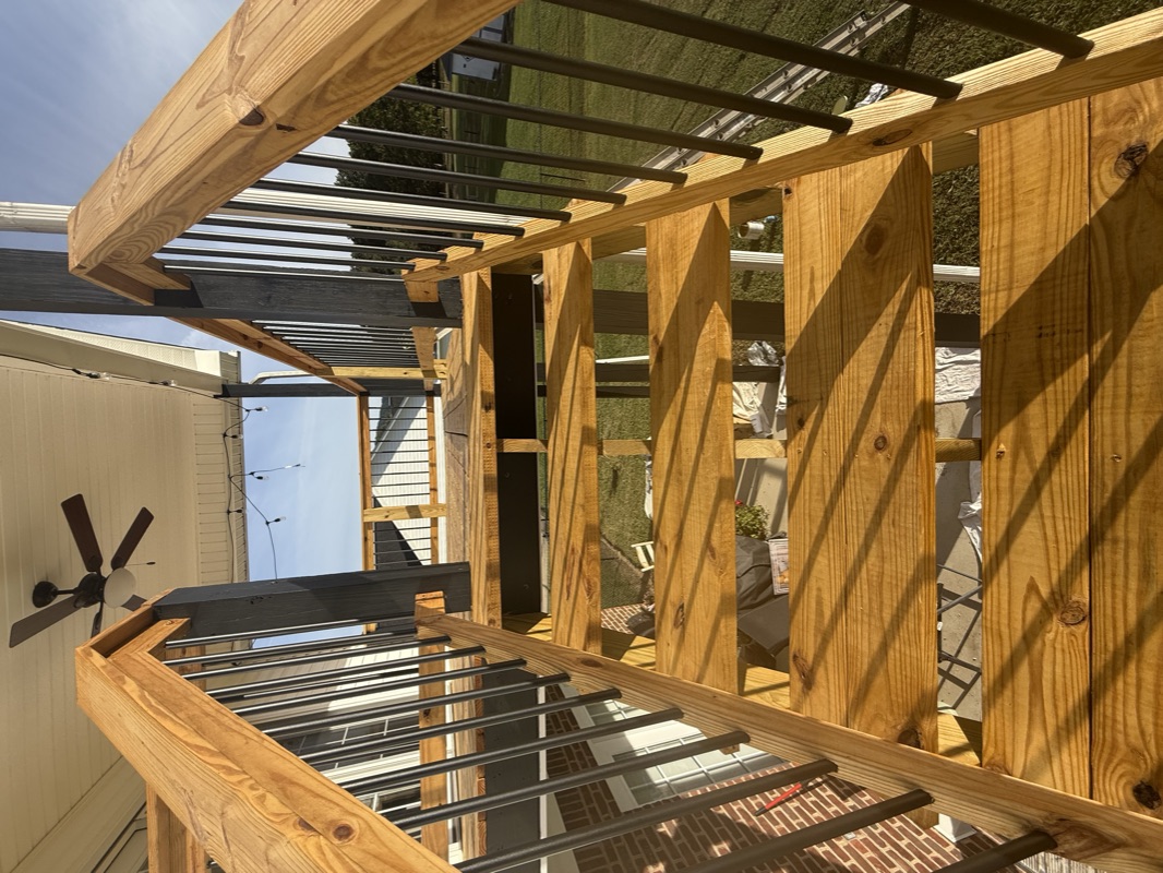 Stained pergola and deck woodwork with rich golden finish