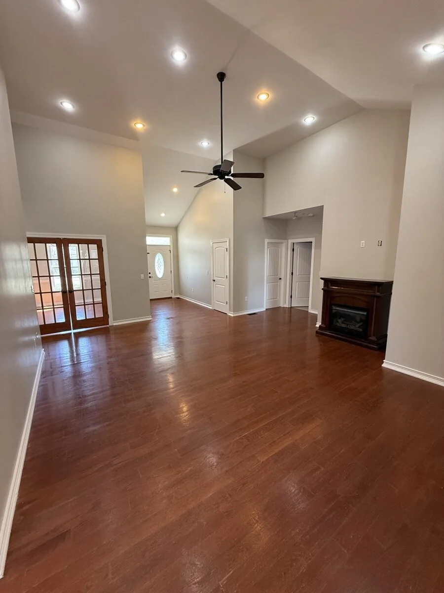 Interior painting of open living room with vaulted ceiling