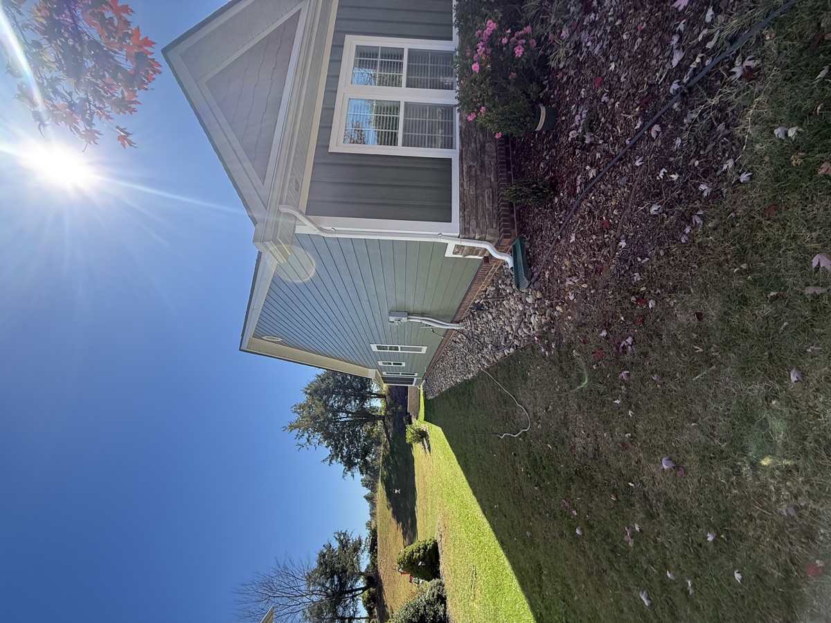 Gray house exterior painting with autumn landscaping