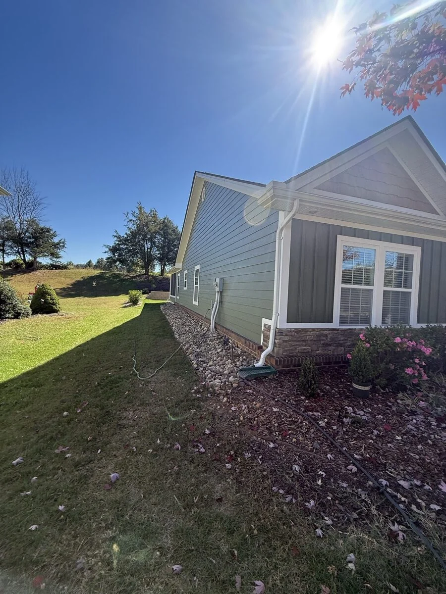 Gray house exterior painting with autumn landscaping